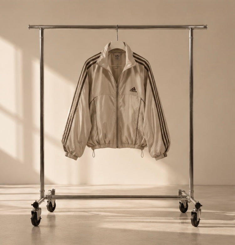 2004 Adidas beige windbreaker hanging on a rail
